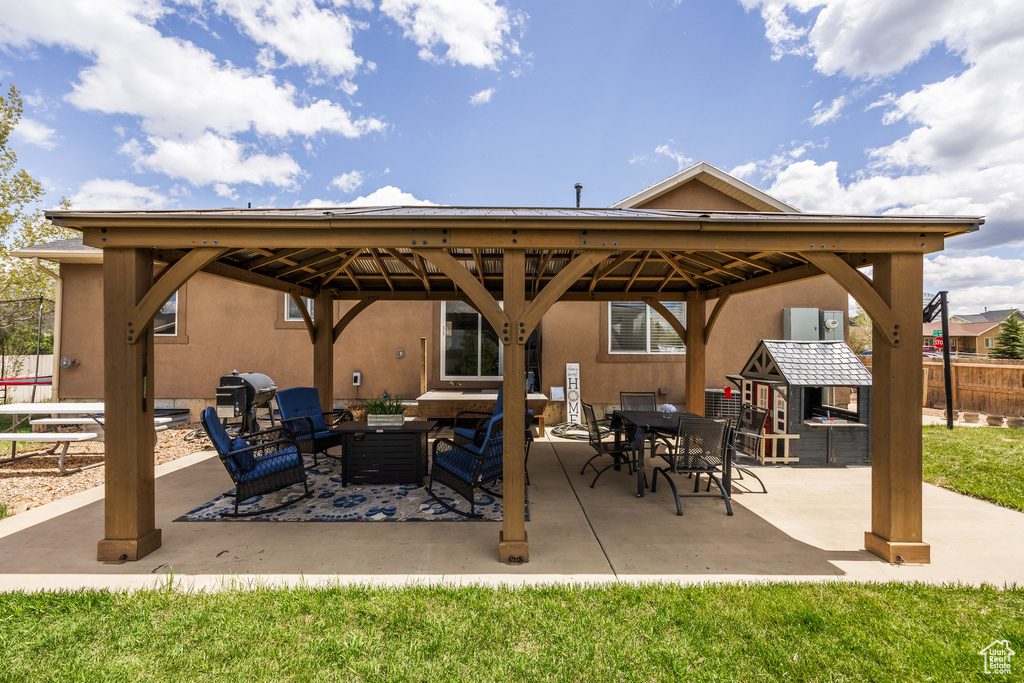 View of patio with a gazebo and outdoor lounge area