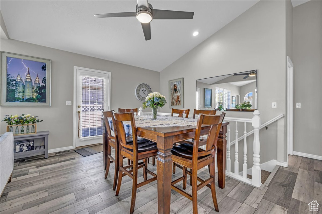 Dining area featuring ceiling fan, wood finished floors, high vaulted ceiling, baseboards, and recessed lighting