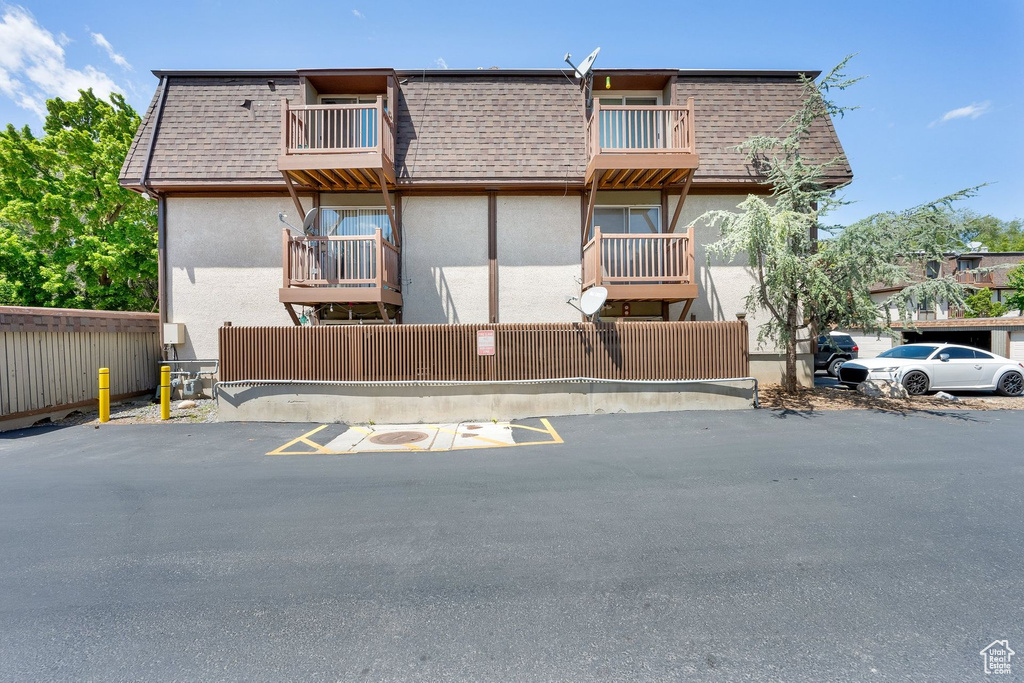 View of property featuring uncovered parking
