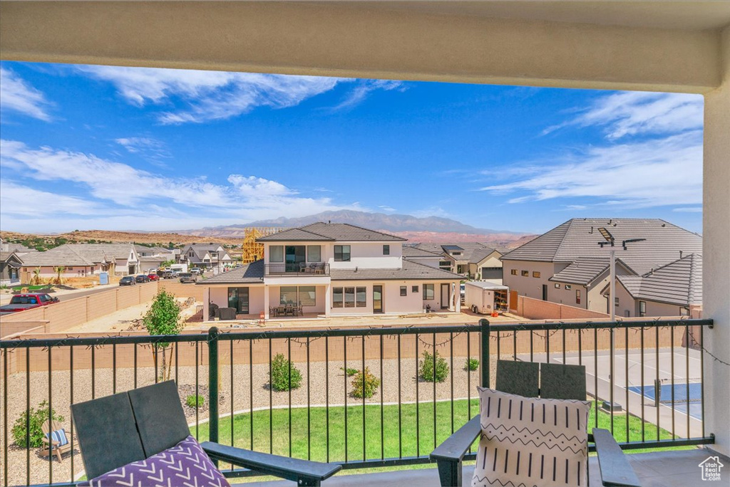 Balcony featuring a residential view and a mountain view