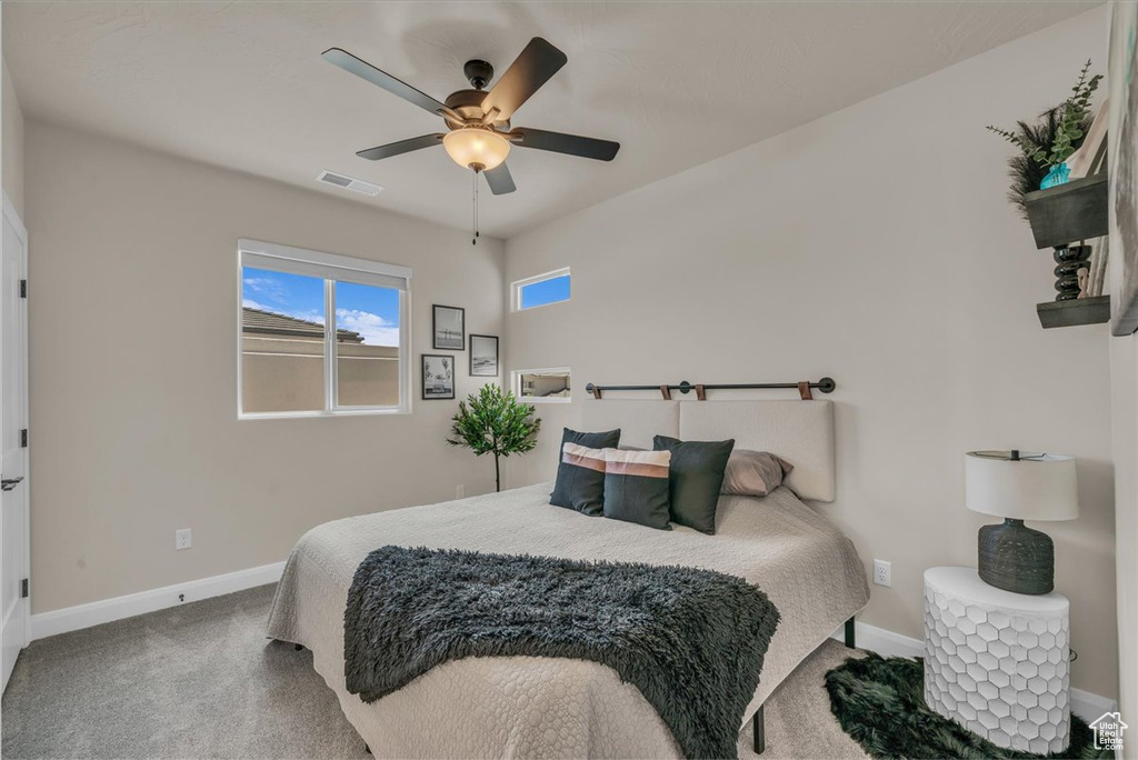 Bedroom featuring carpet, baseboards, and ceiling fan