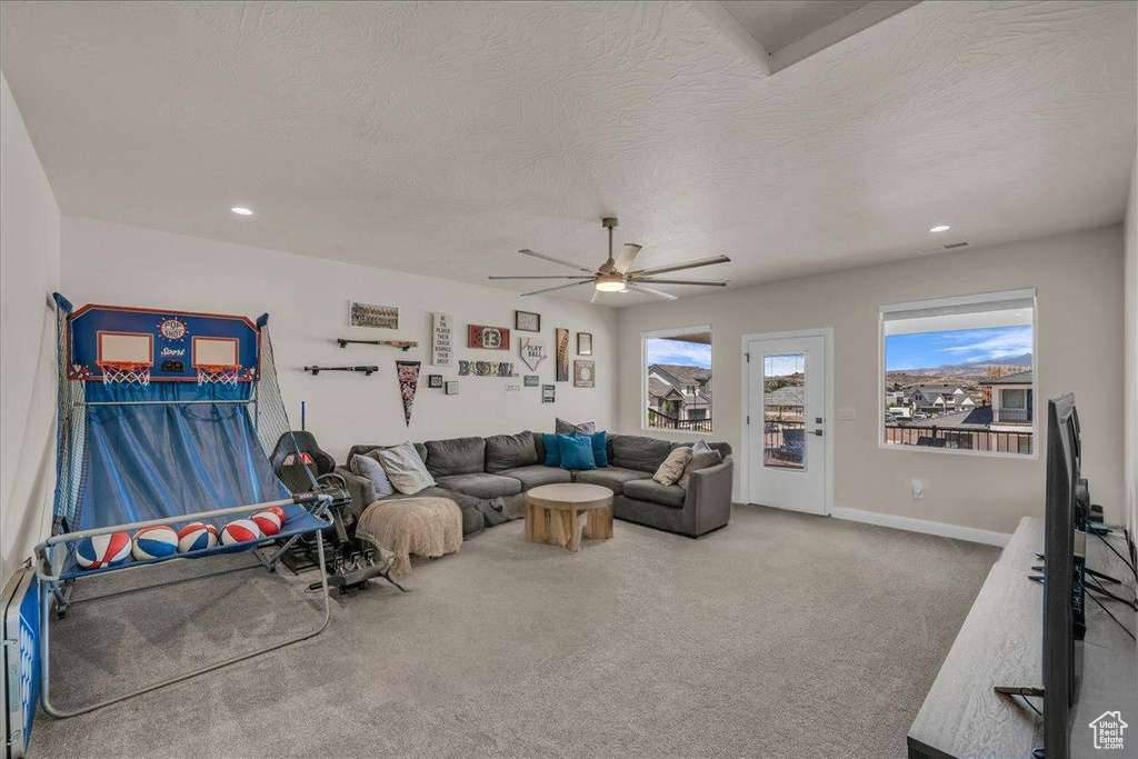Carpeted living room with a ceiling fan, a textured ceiling, recessed lighting, and baseboards