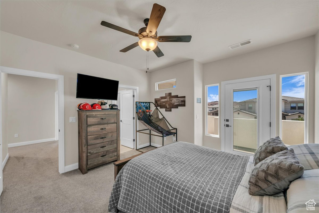 Bedroom with access to outside, light carpet, baseboards, and ceiling fan