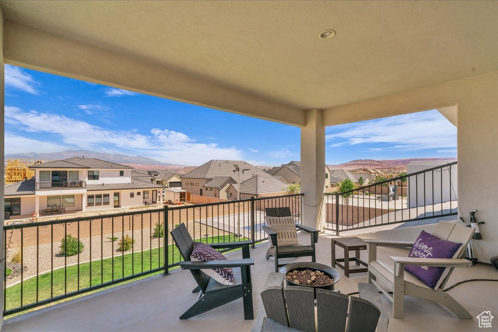 Balcony featuring a residential view and an outdoor fire pit
