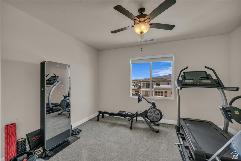 Workout room with carpet floors, a ceiling fan, and baseboards