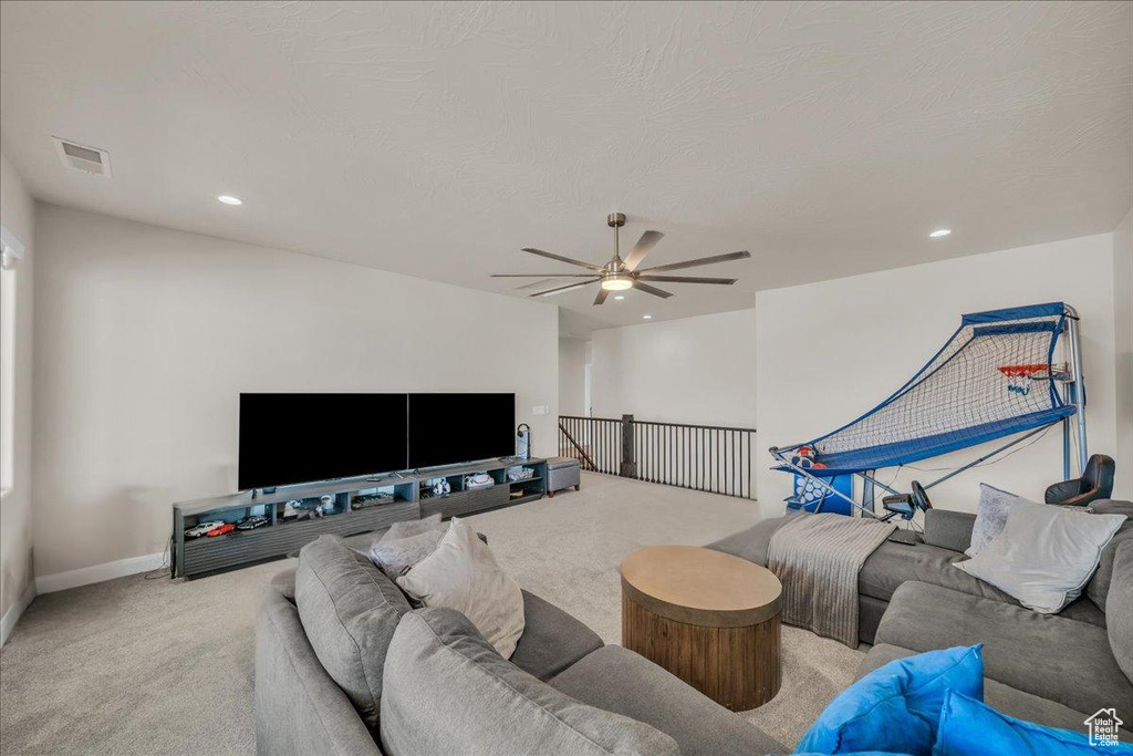 Living area with carpet floors, ceiling fan, recessed lighting, and baseboards