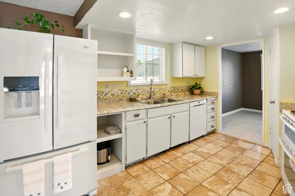Kitchen featuring white appliances, open shelves, a sink, white cabinetry, and recessed lighting
