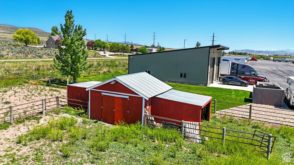 View of pole building with a mountain view