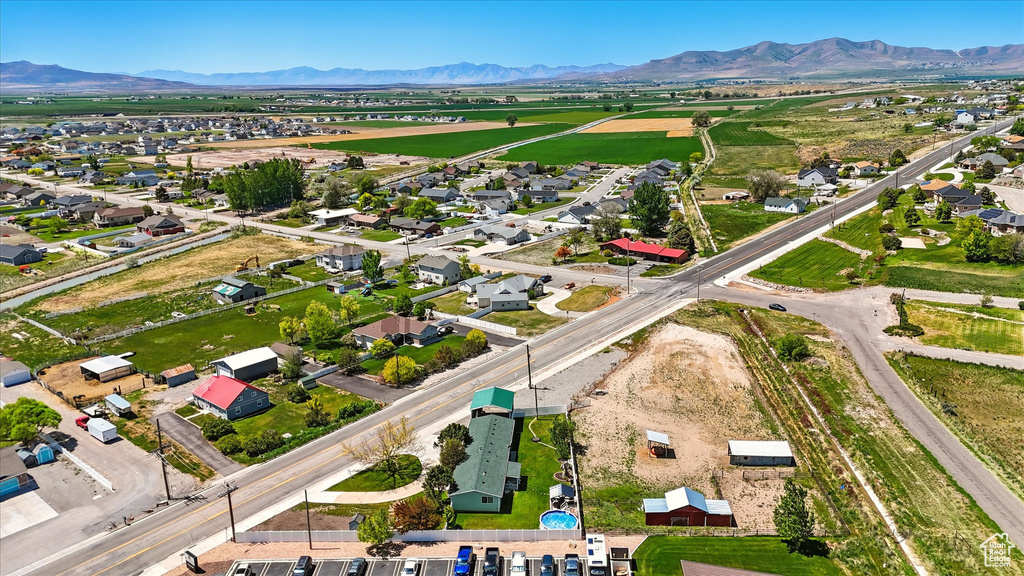 Aerial view of property\'s location with a mountain backdrop and nearby suburban area