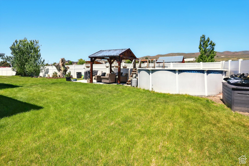 View of yard with a gazebo and outdoor lounge area