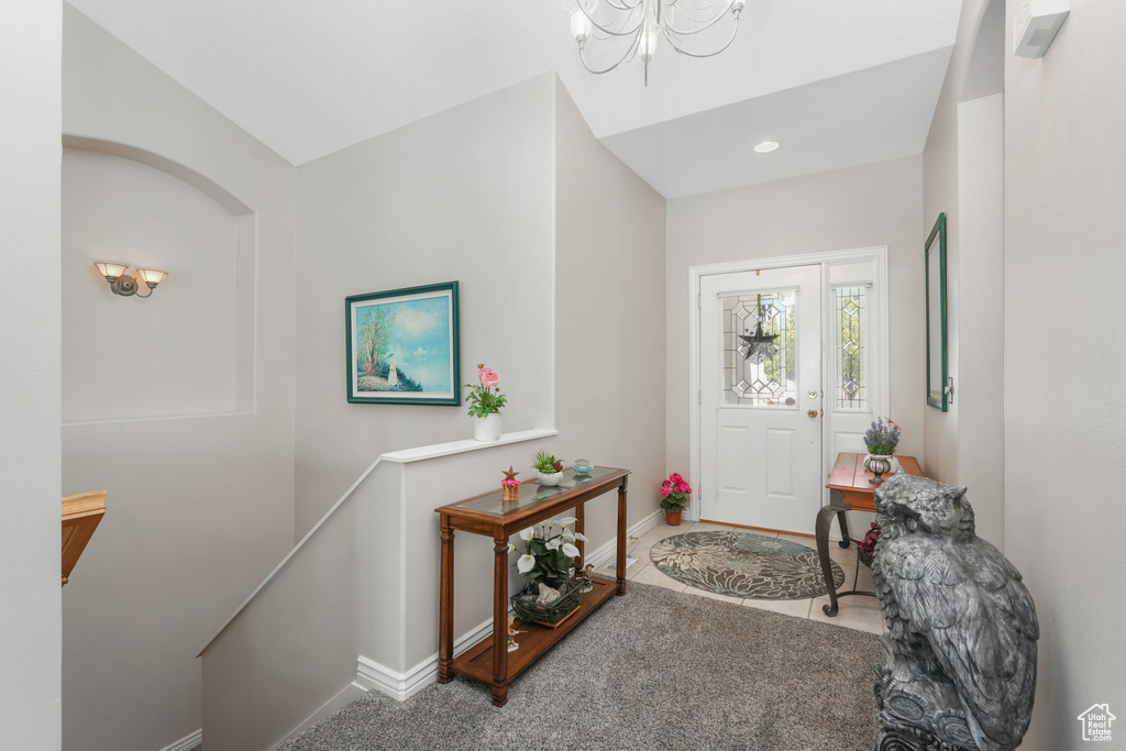 Foyer with baseboards, a chandelier, recessed lighting, and tile patterned flooring