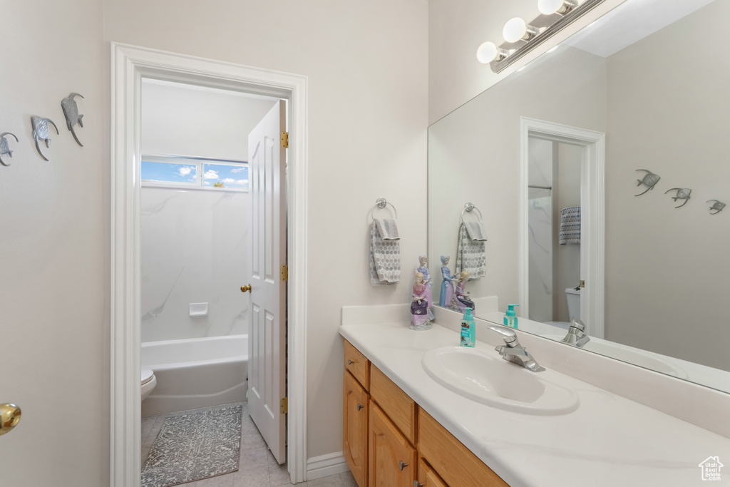 Bathroom with tile patterned floors and vanity