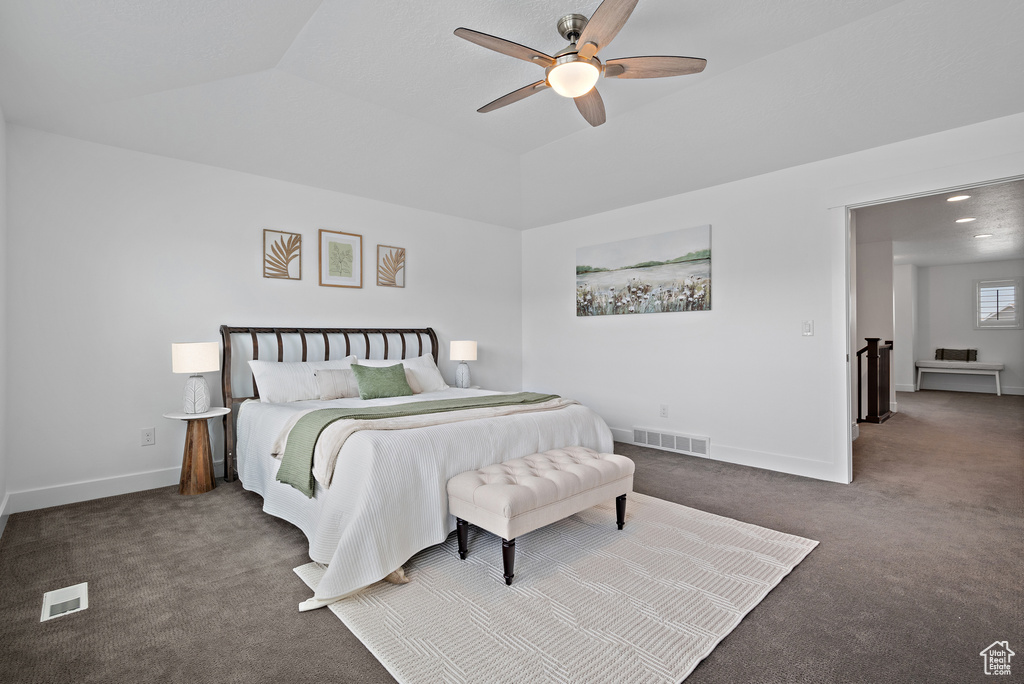Carpeted bedroom with baseboards and a ceiling fan