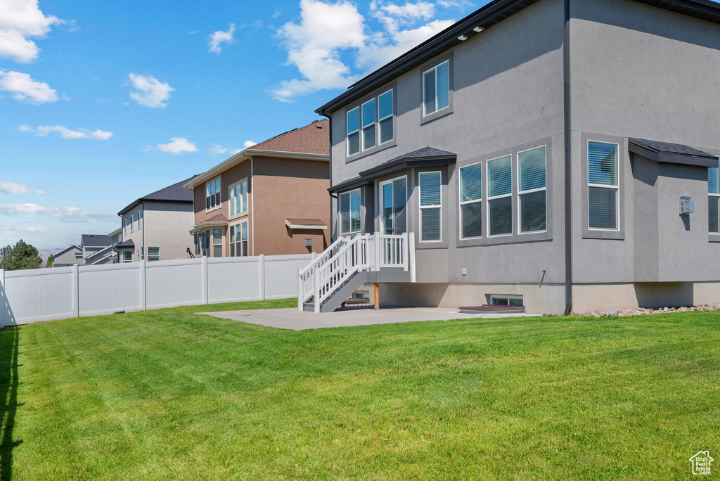 Rear view of property with a patio and stucco siding