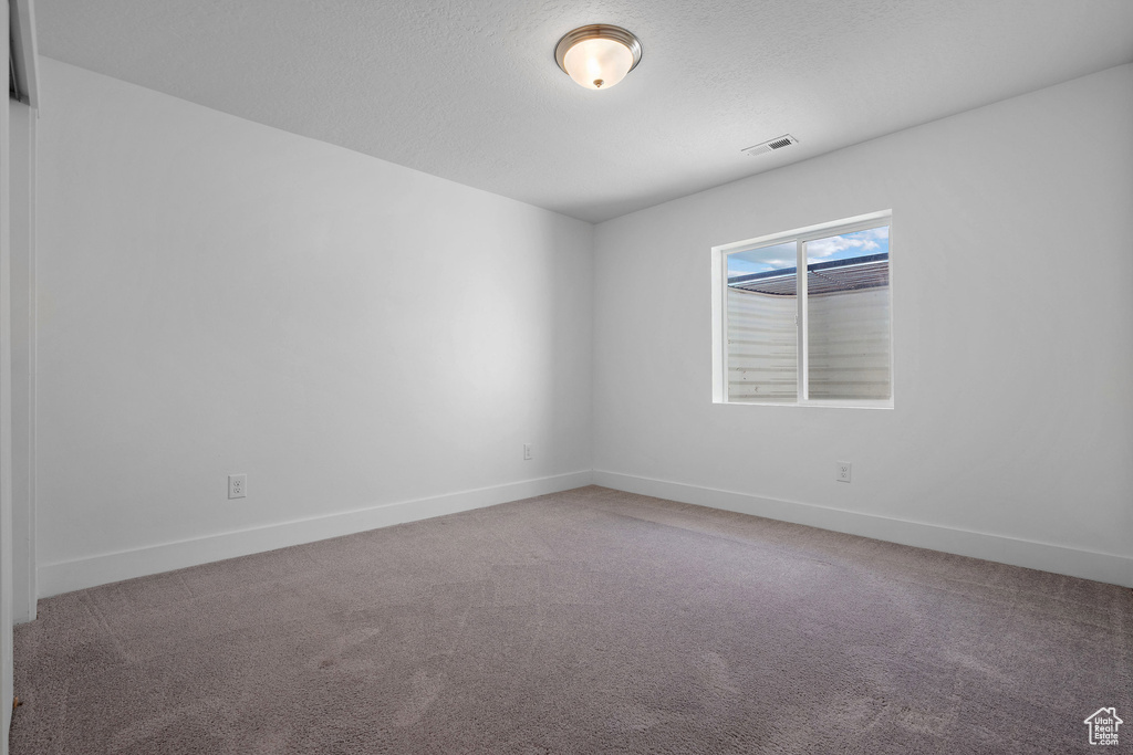 Unfurnished room featuring carpet and baseboards