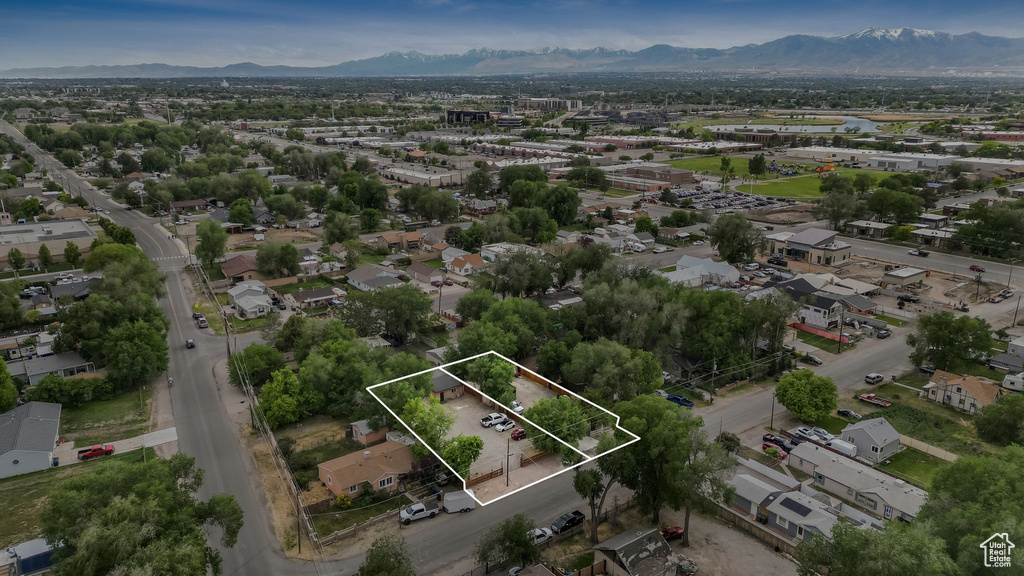 Aerial view of property and surrounding area featuring mountains and property boundaries highlighted