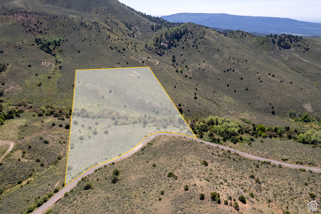 Aerial view of sparsely populated area featuring mountains and property parcel outlined