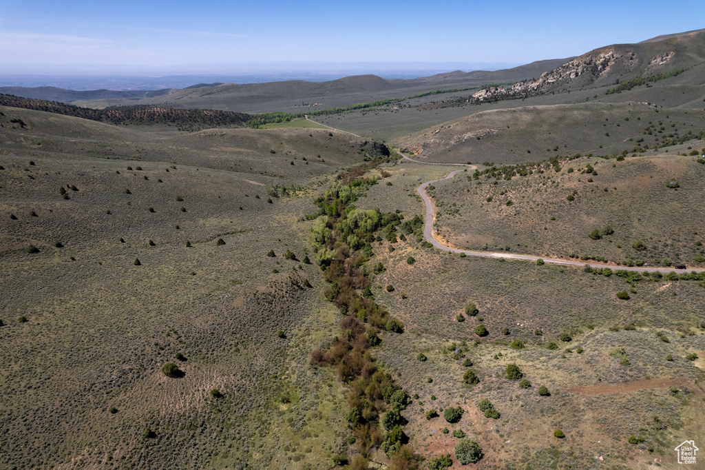 Aerial overview of property's location with a mountain backdrop, a desert landscape, and rural landscape