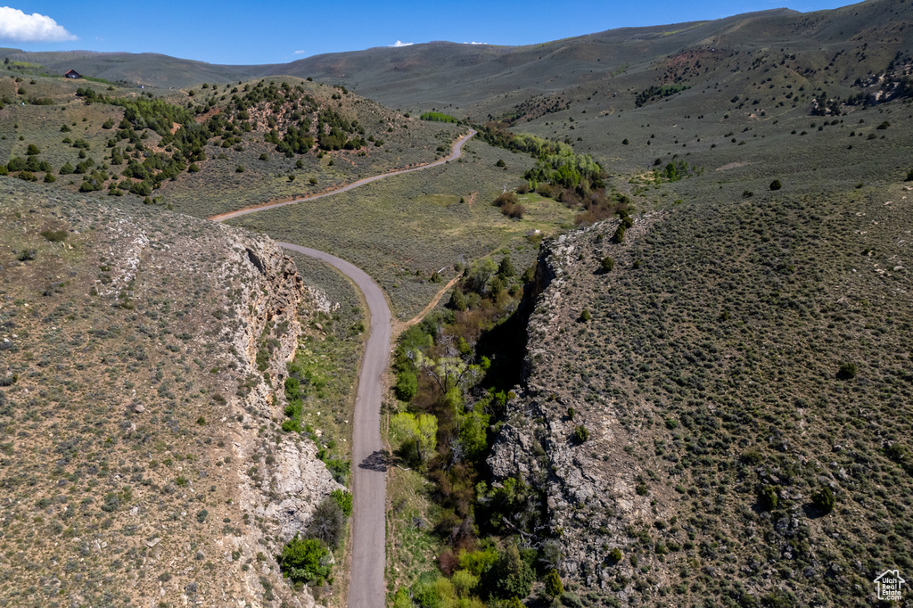 Aerial view of property's location featuring a mountainous background