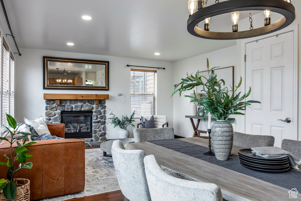 Living area featuring a chandelier, wood finished floors, a fireplace, and recessed lighting