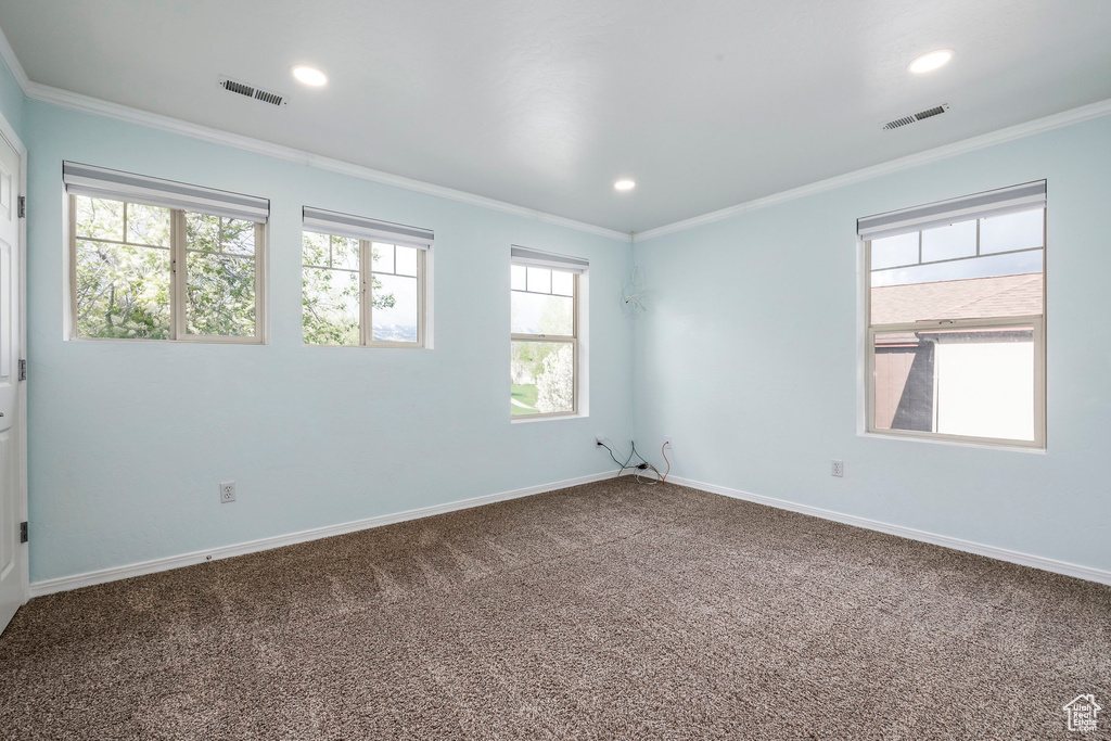 Unfurnished room with crown molding, carpet flooring, baseboards, and recessed lighting