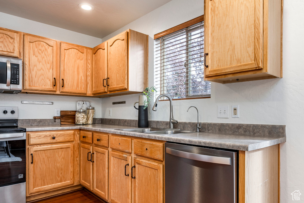 Kitchen featuring appliances with stainless steel finishes, a sink, and recessed lighting