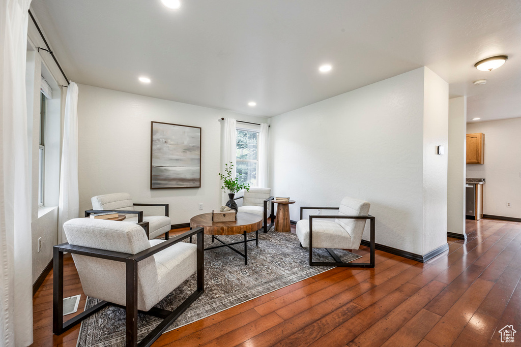 Living area featuring dark wood-type flooring, recessed lighting, and baseboards