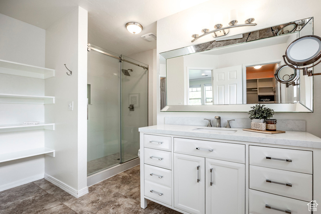 Bathroom featuring a stall shower and vanity