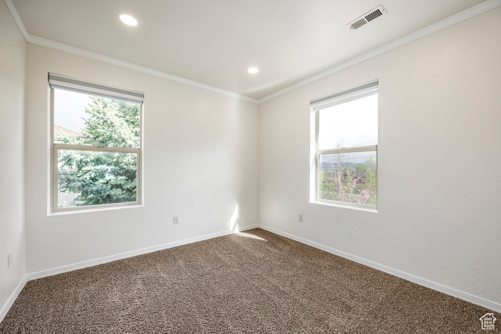 Spare room with carpet, baseboards, recessed lighting, and ornamental molding