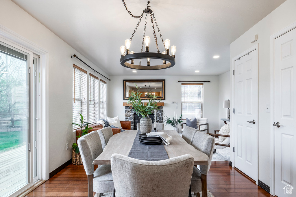 Dining space with a chandelier, wood finished floors, and recessed lighting