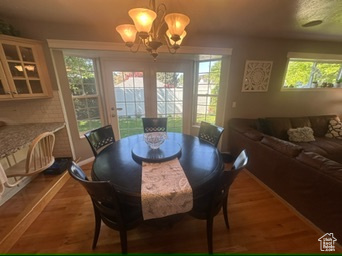Dining area with a chandelier and wood finished floors