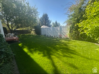 View of yard with a wooden deck