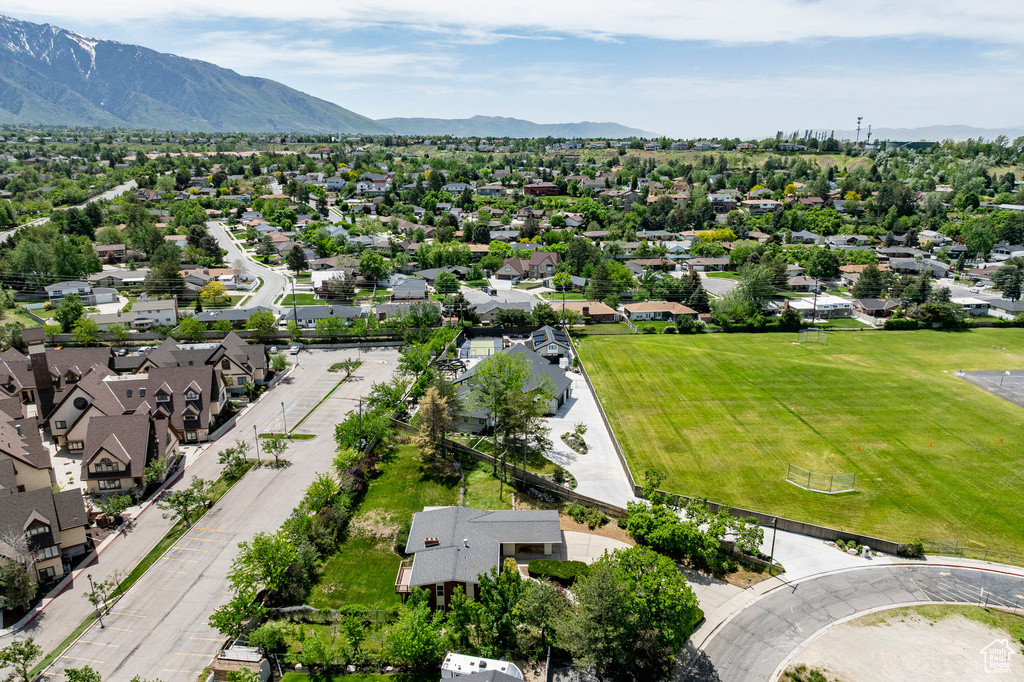 Aerial perspective of suburban area featuring a mountain backdrop