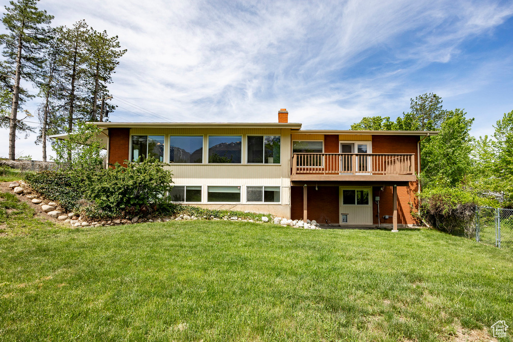 Rear view of house with a chimney and a deck