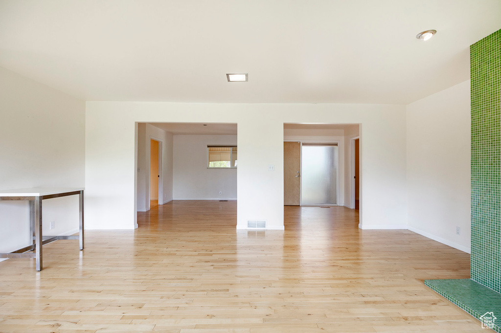 Unfurnished room featuring light wood-style floors and baseboards