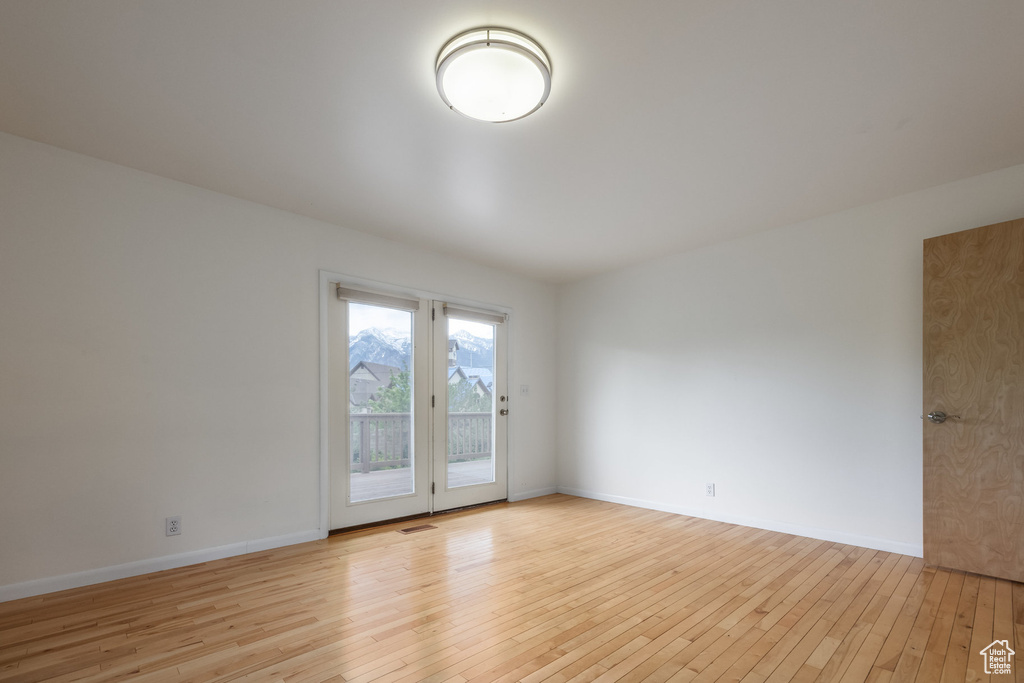 Empty room with light wood-style flooring and baseboards