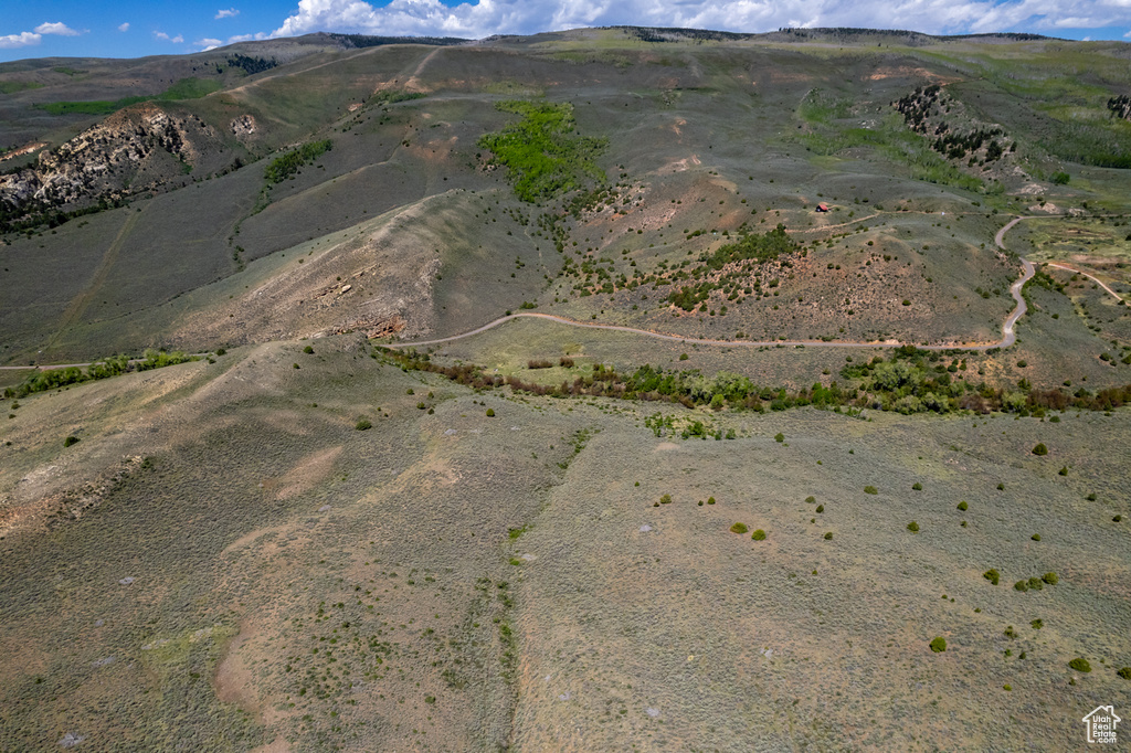 Aerial overview of property\'s location with a mountain backdrop and rural landscape