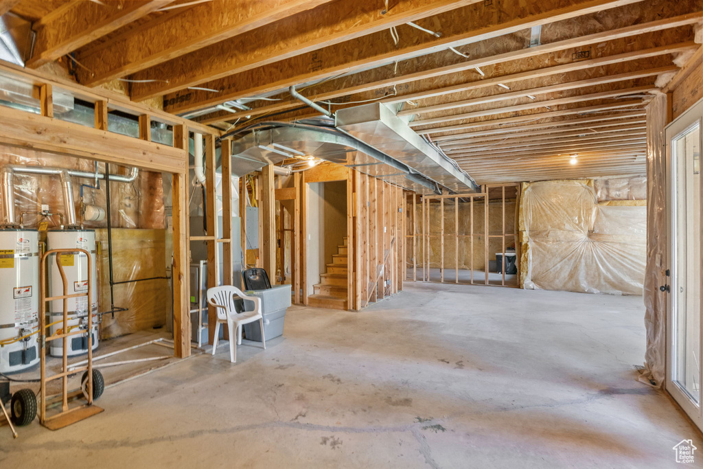 Unfinished below grade area with gas water heater and strapped water heater