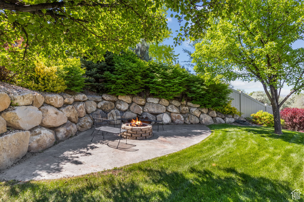View of yard featuring a fire pit and a patio