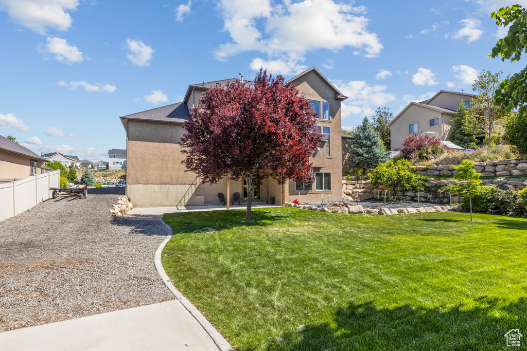 Back of house featuring stucco siding and a patio