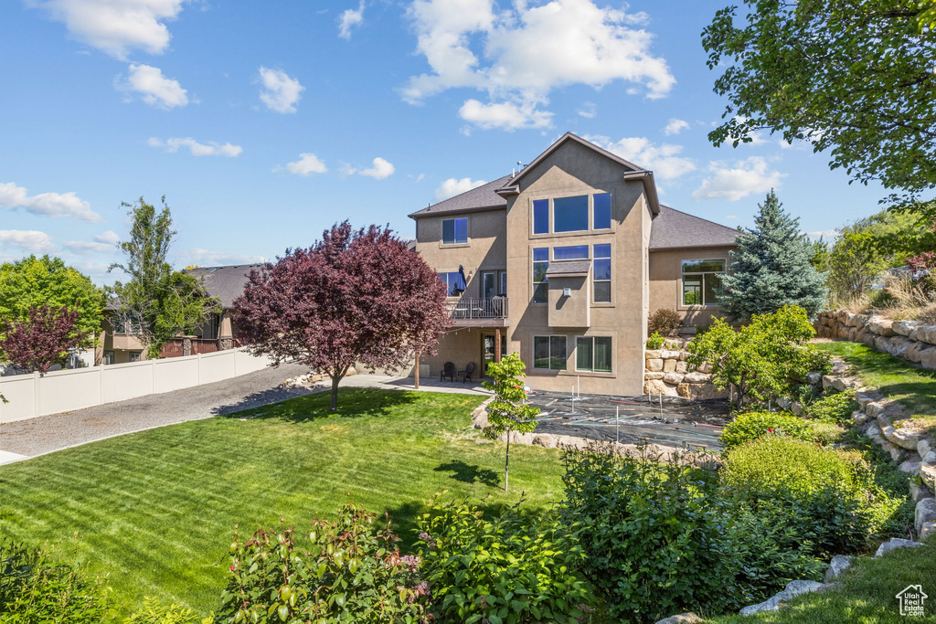 Rear view of property with stucco siding and a patio