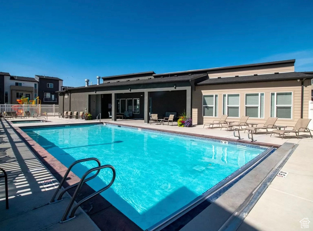 Community pool featuring a patio area