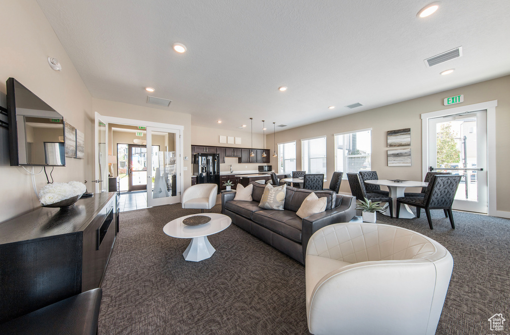 Carpeted living area with recessed lighting