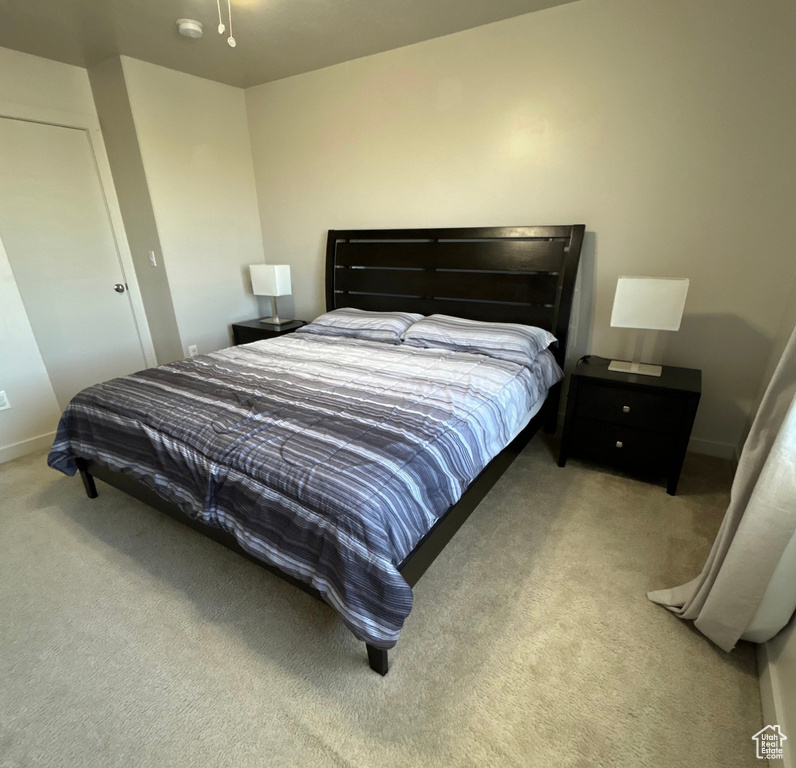 Bedroom with carpet flooring and baseboards