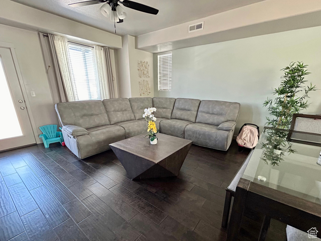 Living room featuring ceiling fan and dark wood finished floors