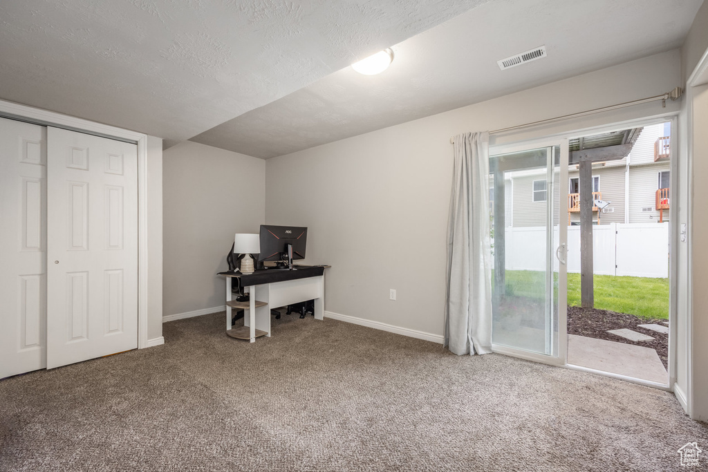 Home office featuring carpet floors and baseboards