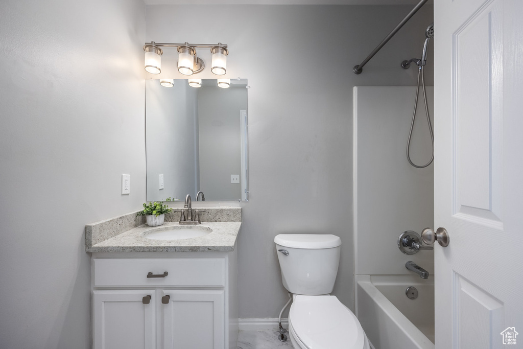 Full bathroom featuring vanity, toilet, and bathtub / shower combination
