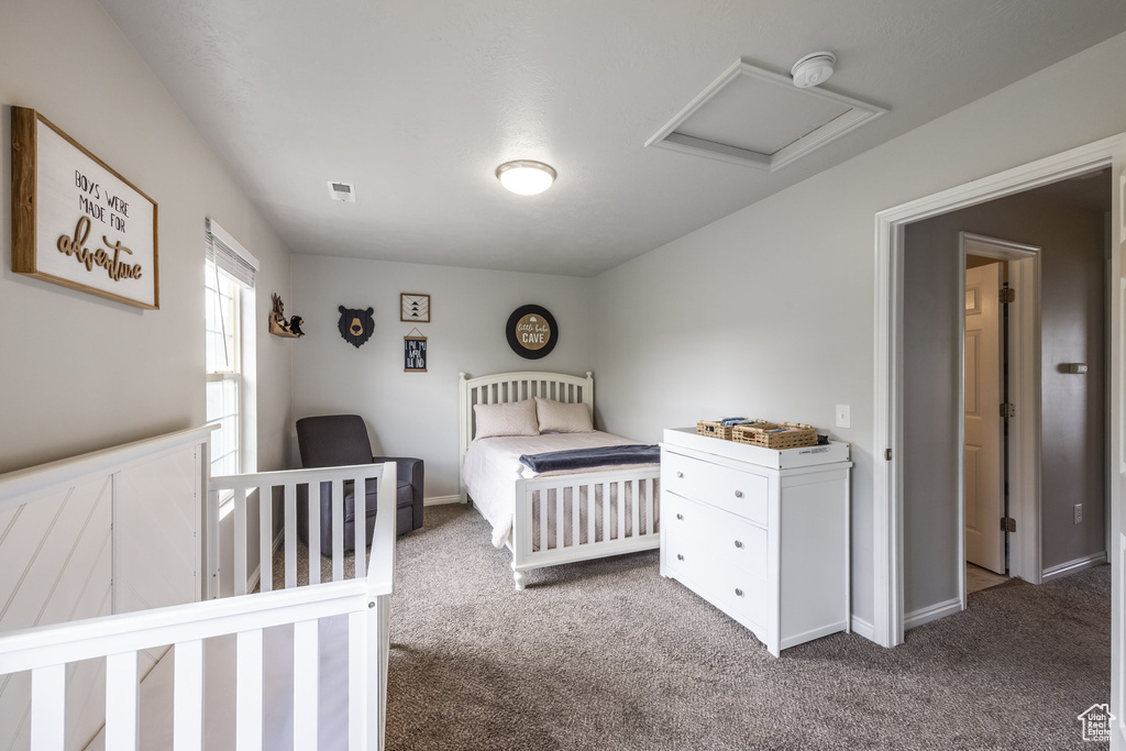 Bedroom featuring carpet and attic access