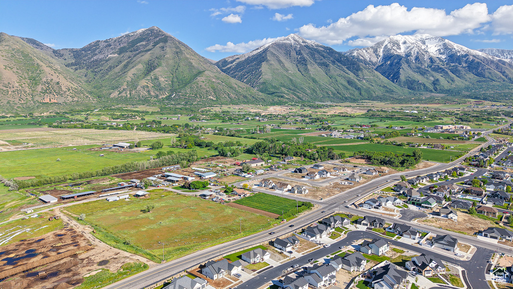 Aerial view of property's location featuring nearby suburban area and a mountainous background