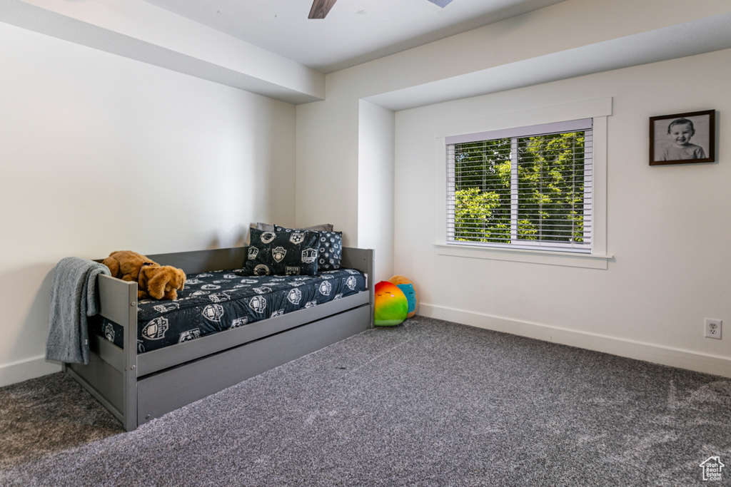 Bedroom featuring carpet flooring, baseboards, and a ceiling fan